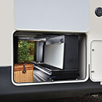 This party slide is only 20” wide, and tucks nicely into most
fifth wheel front storage compartments. It packs a whopping
punch with a 50” hidden TV on a double lift, a fold-up
countertop with hidden storage, 110V mini refrigerator,
and a Suburban gas griddle on a steel slide out tray. May Show Optional Features. Features and Options Subject to Change Without Notice.