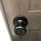 Black Door Handle in Bathroom May Show Optional Features. Features and Options Subject to Change Without Notice.