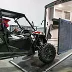 Four seat side-by-side being loaded into the garage May Show Optional Features. Features and Options Subject to Change Without Notice.