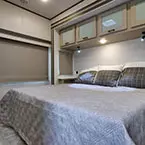 Rear Bedroom with King Bed and Overhead Cabinets May Show Optional Features. Features and Options Subject to Change Without Notice.