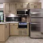 Kitchen with Residential Refrigerator, Overhead Microwave, Oven, Overhead Cabinets, and Double Basin Sink with Pull-Out Sprayer May Show Optional Features. Features and Options Subject to Change Without Notice.