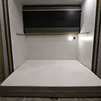 Off-Door Side Slideout in Bunkhouse with Top Bunk Up and Versa-Queen in Sleeping Position May Show Optional Features. Features and Options Subject to Change Without Notice.