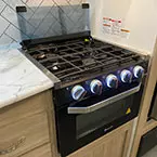 3 burner range with flush glass top shown flipped up and LED accent lights May Show Optional Features. Features and Options Subject to Change Without Notice.