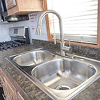 Dual basin sink and high rise faucet with pull down sprayer May Show Optional Features. Features and Options Subject to Change Without Notice.