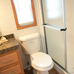 View into bathroom with toilet and shower with sliding glass door May Show Optional Features. Features and Options Subject to Change Without Notice.