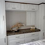 Dresser with countertop and overhead storage cabinets with wardrobe cabinets on the sides May Show Optional Features. Features and Options Subject to Change Without Notice.
